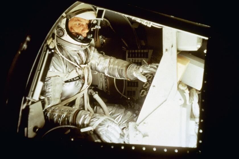 John Glenn sits inside the training capsule, January 11, 1961, in preparation for manned space flight.