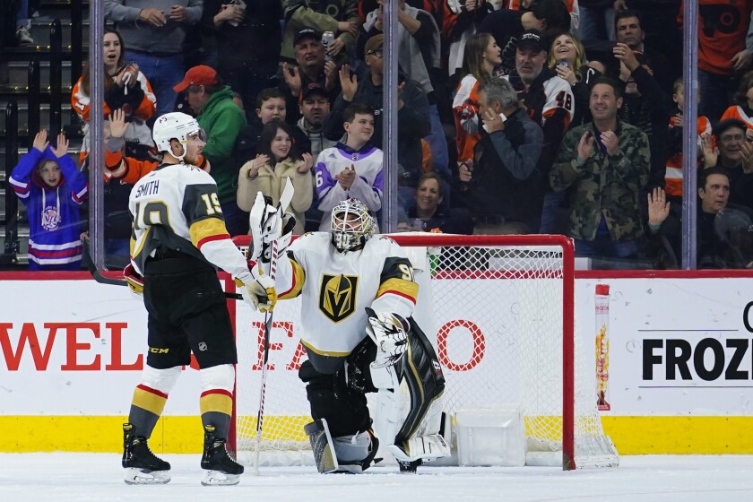 Vegas Golden Knights' Reilly Smith, left, and Robin Lehner react after a goal by Philadelphia Flyers' Oskar Lindblom during the first period of an NHL hockey game, Tuesday, March 8, 2022, in Philadelphia. (AP Photo/Matt Slocum)
