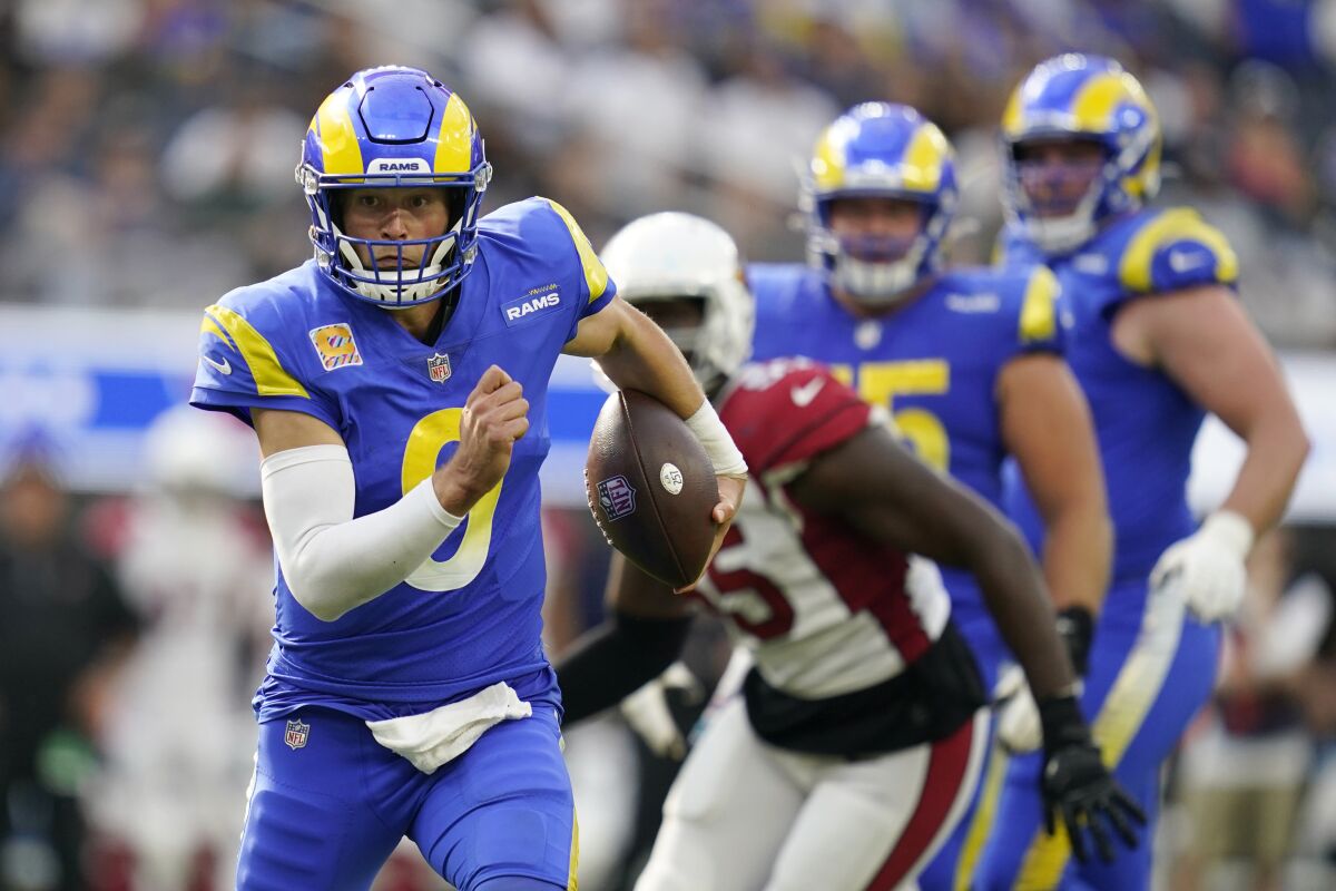 Los Angeles Rams quarterback Matthew Stafford rolls out during the second half in an NFL football game against the Arizona Cardinals Sunday, Oct. 3, 2021, in Inglewood, Calif. (AP Photo/Ashley Landis)