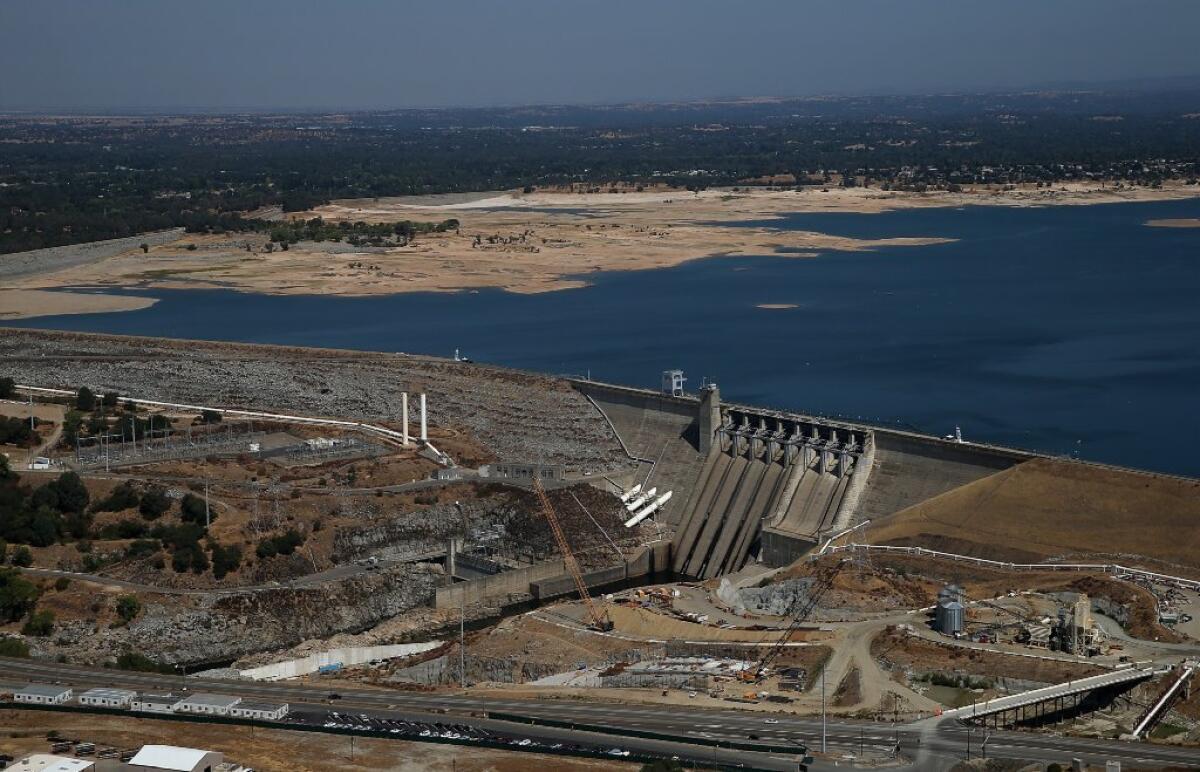 Folsom Lake's low water level can be seen behind the Folsom Dam in a photo taken Aug. 19.