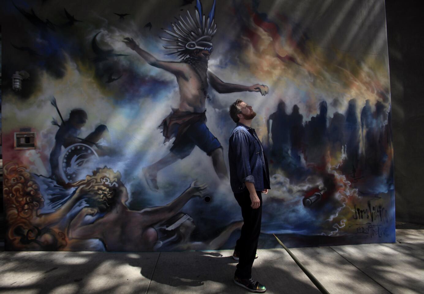 Oliver Luckett, cofounder and chief executive of tech start-up theAudience, stands in front of a mural painted by street artist Jim Rockwell, a.k.a. Jim Vision, on one of his offices in Los Angeles.