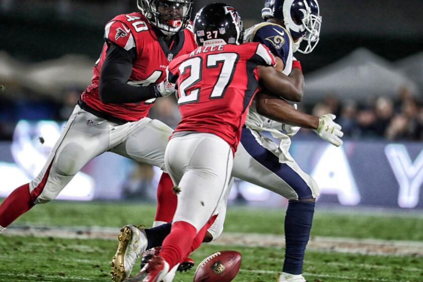 LOS ANGELES, CA, SATURDAY, JANUARY 6, 2018 - Falcons safety Damontae Kazee strips the ball from Rams kick returner Pharoh Cooper for a first quarter turnover in the NFL Wild Card playoff game at the Coliseum. (Robert Gauthier/Los Angeles Times)