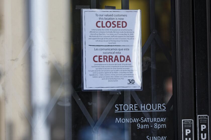 SAN YSIDRO, CA - OCTOBER 29: Along San Ysidro Blvd., one shop posted a sign to inform their customers that due COVID-19 they made the decision to Òclose all our Baja Duty Free stores, as of Tuesday May 26, 2020.Ó Many businesses in San Ysidro would be at risk if the land travel restrictions, which have been imposed for seven months on the U.S.-Mexico border, are extended once again. (Nelvin C. Cepeda / The San Diego Union-Tribune)