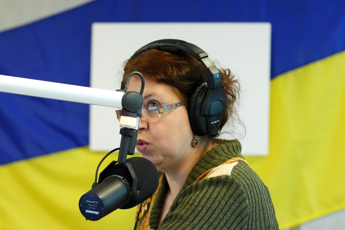 Natalia Churikova editor in chief of Radio Ukraine speaks at the studio in Prague, Czech Republic, Thursday, March 31, 2022. The new Prague-based internet radio has started to broadcast news, information and music tailored to address the day-to-day needs and worries of some 300,000 refugees who have arrived in the Czech Republic after Russia launched its military assault against Ukraine. (AP Photo/Petr David Josek)
