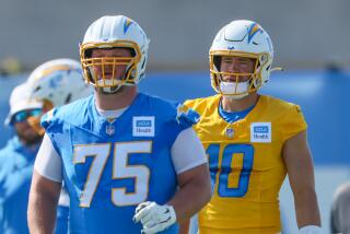 Chargers quarterback Justin Herbert and center Bradley Bozeman approach the line.