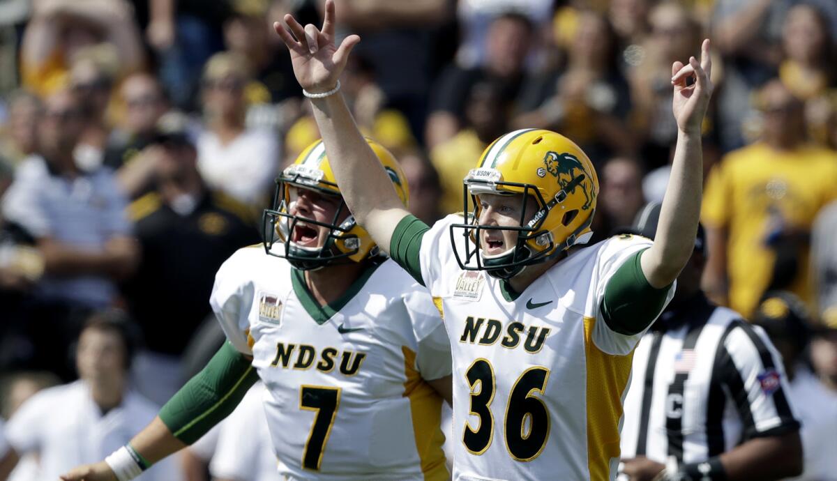 North Dakota State kicker Cam Pedersen (36) reacts with holder Cole Davis (7) after kicking a 37-yard field goal on the final play to beat Iowa in September, something Michigan could not do in November.