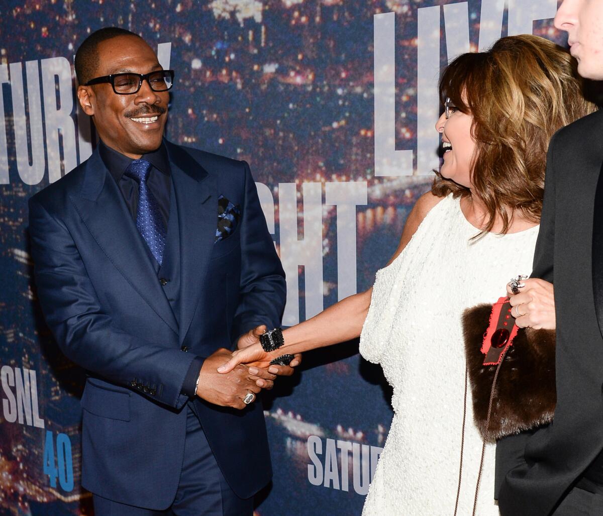 Actor Eddie Murphy greets former Alaska Gov. Sarah Palin on the "Saturday Night Live 40th Anniversary Special" red carpet on February 15, 2015. Murphy and Palin have no children together.