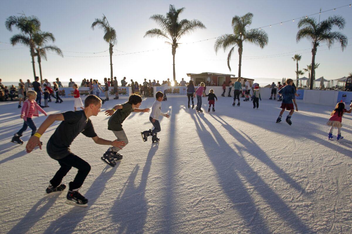 Young skaters zoom around the Skating by the Sea ice skating rink at the Hotel del Coronado. (Hayne Palmour IV • U-T)
