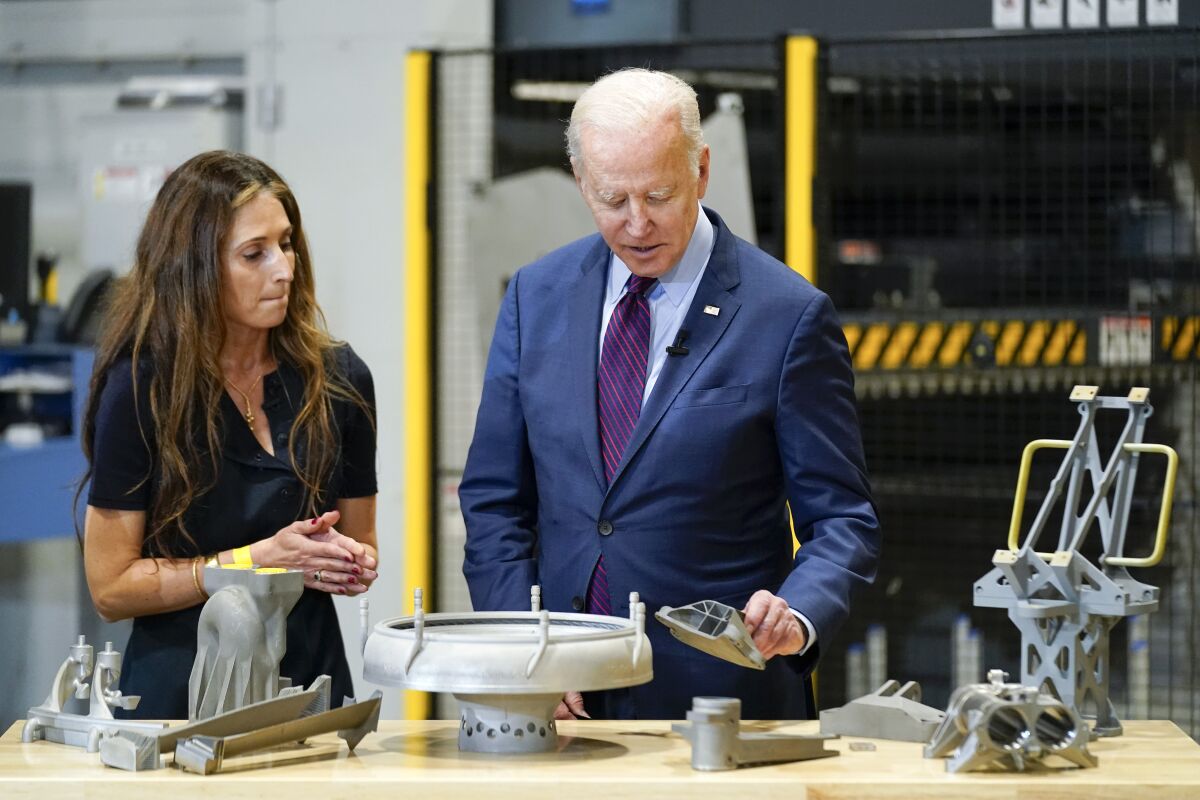 President Joe Biden speaks with Joanna Zelaya, CEO of Chicago Precision, during a tour at United Performance Metals in Hamilton, Ohio, Friday, May 6, 2022. (AP Photo/Andrew Harnik)