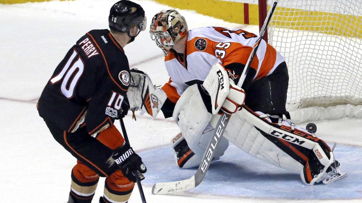 Anaheim Ducks' Corey Perry (10) handles the puck in an NHL hockey