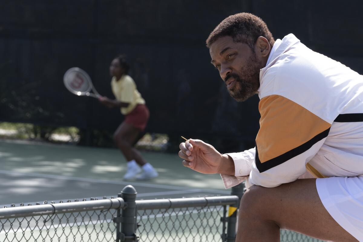 Saniyya Sidney as Venus Williams and Will Smith as Richard Williams on the tennis court in the movie "King Richard."
