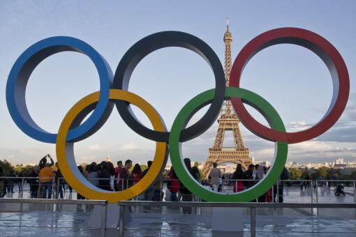 FILE - The Olympic rings are set up at Trocadero plaza that overlooks the Eiffel Tower.