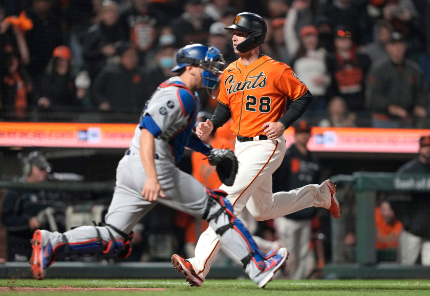 San Francisco's Buster Posey scores in front of Dodgers catcher Will Smith during a game on Sept. 3.