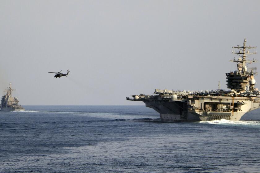 FILE - The aircraft carrier USS Dwight D. Eisenhower and other warships crosses the Strait of Hormuz into the Persian Gulf on Sunday, Nov. 26, 2023. (Information Technician Second Class Ruskin Naval/U.S. Navy via AP, file)