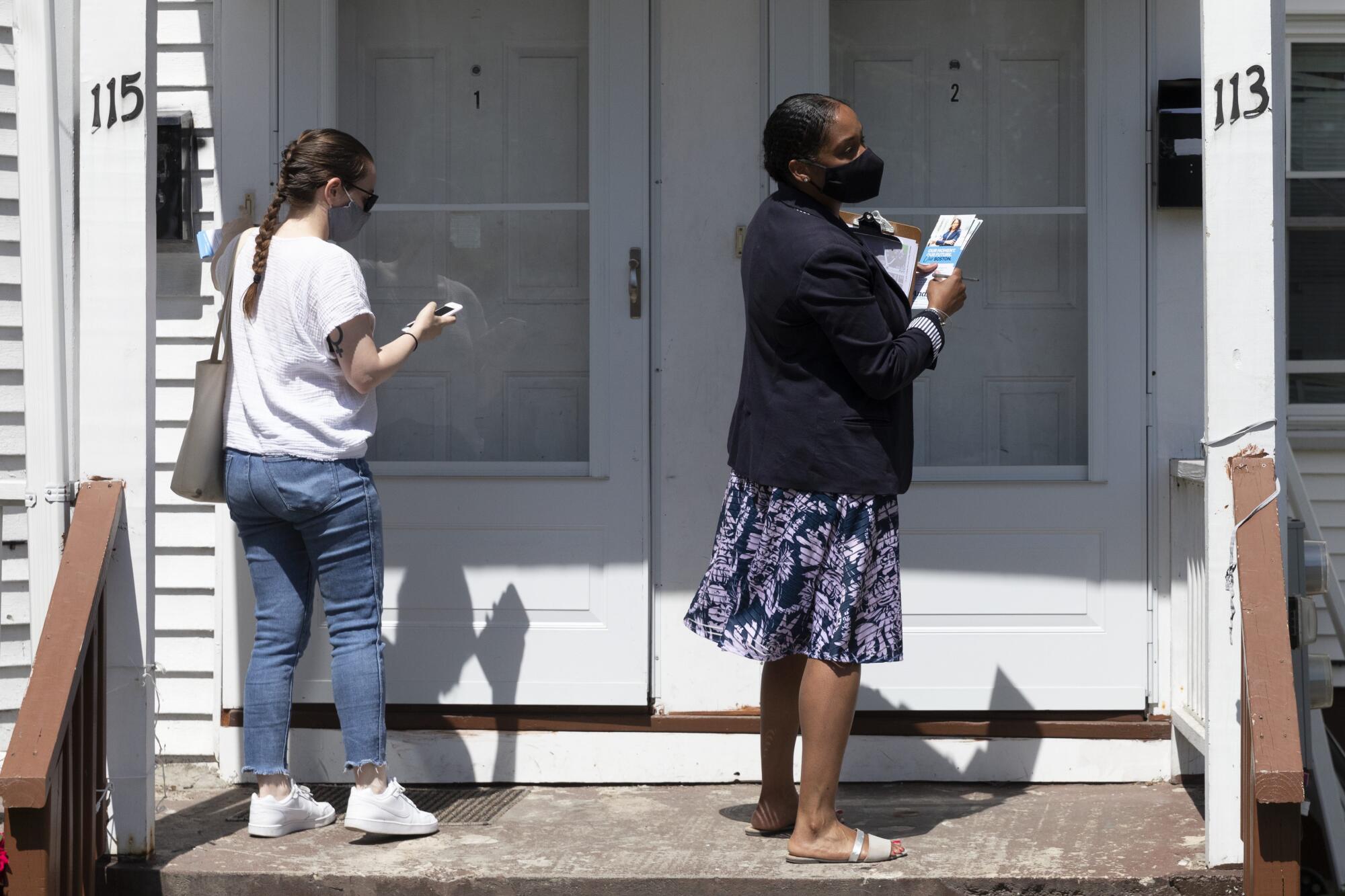 Boston mayoral candidate Andrea Campbell, right, canvasses with her communications director Caroline Kimball-Katz.