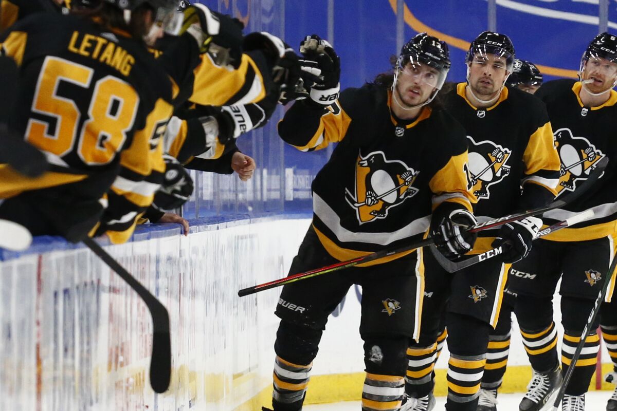 Pittsburgh Penguins forward Brandon Tanev (13) celebrates his goal during the second period of an NHL hockey game against the Buffalo Sabres, Thursday, March 11, 2021, in Buffalo, N.Y. (AP Photo/Jeffrey T. Barnes)