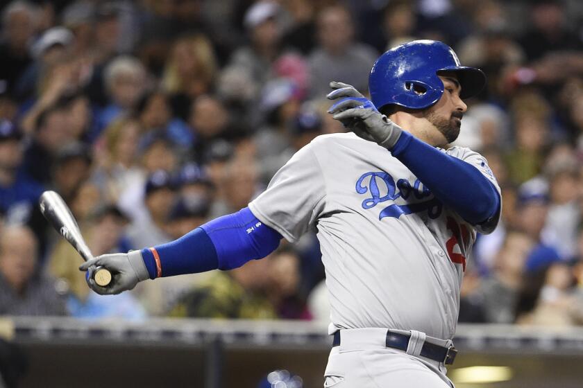 Dodgers first baseman Adrian Gonzalez follows through on a run-scoring single against the Padres in the third inning Friday night in San Diego.