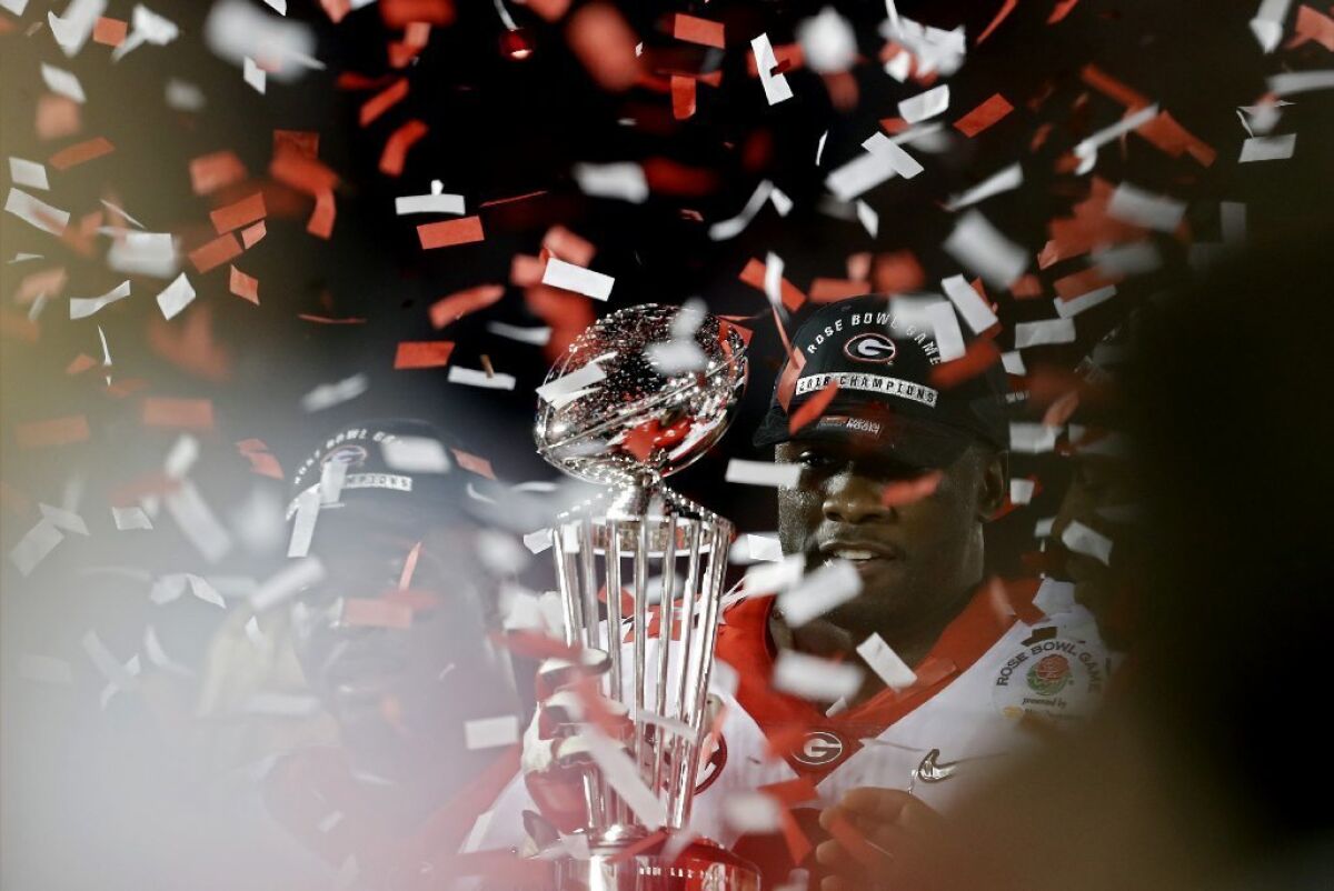 Georgia linebacker Roquan Smith hoists College Football Playoffs semifinal trophy after Georgia beat Oklahoma at the Rose Bowl on Jan. 1.