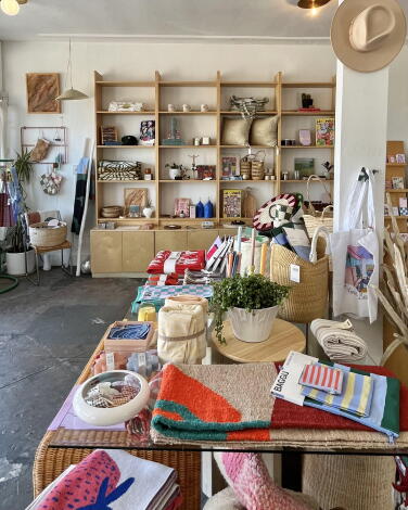 Inside a store with items for sale on walks and shelves.