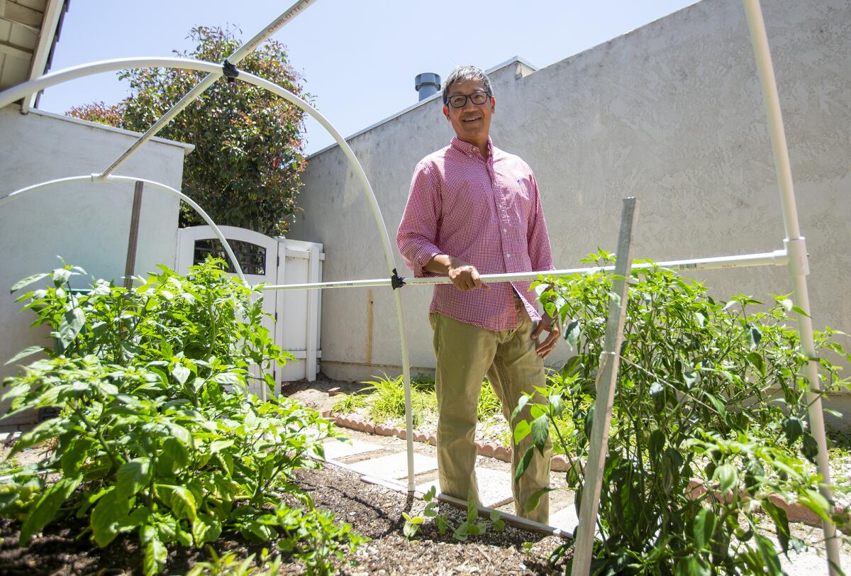 Foo Nguyen shows off his garden at his home in Irvine. 