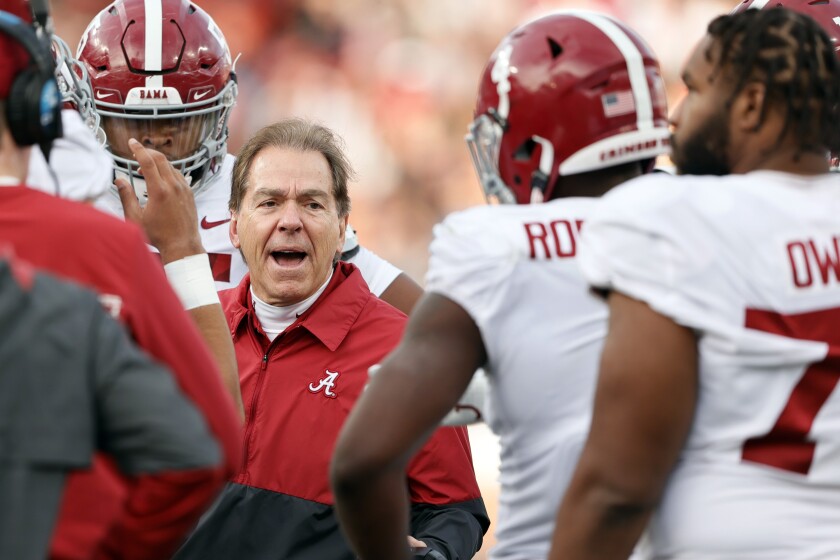 Alabama head coach Nick Saban talks with players in a time out during the first half of an NCAA college football game against Auburn Saturday, Nov. 27, 2021, in Auburn, Ala. (AP Photo/Butch Dill)
