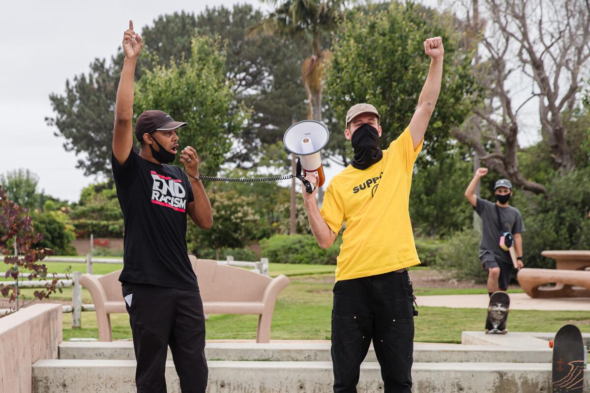 Rod James, left, speaks during a "Pushing for Peace" protest in Encinitas on June 21.