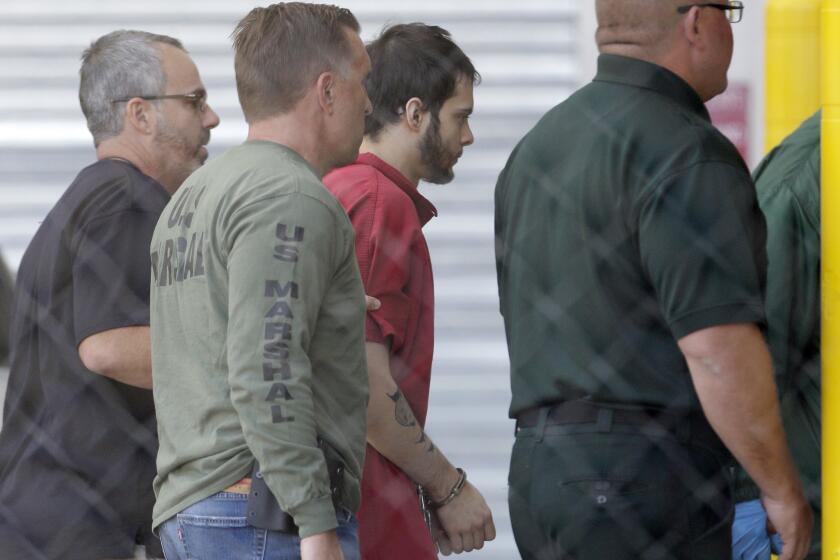 Esteban Santiago, third from left, returns to Broward County's main jail after his first court appearance on Jan 9.
