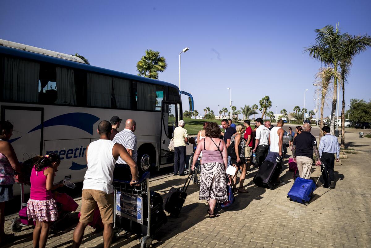 Stranded tourists are loaded onto a bus outside the airport terminal in Sharm el Sheik, Egypt, on on Nov. 5.