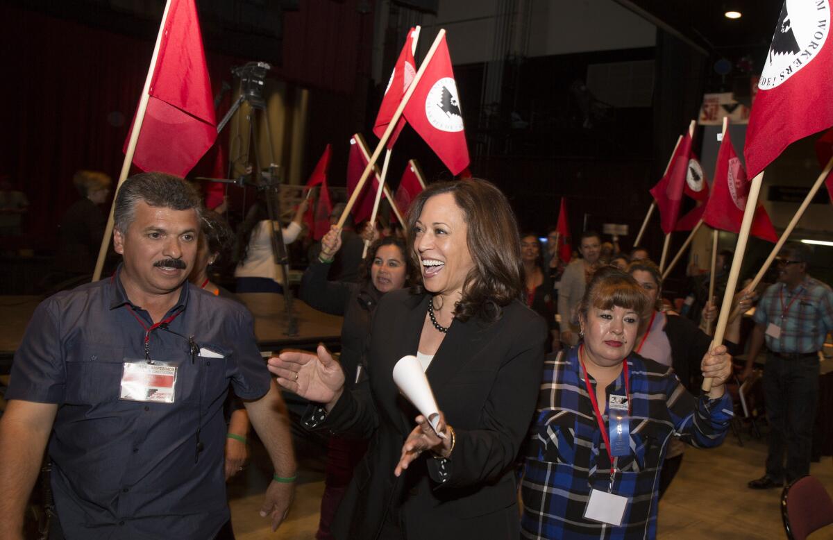 California Atty. Gen. Kamala Harris, a candidate for U.S. Senate, enters the United Farm Workers convention in Bakersfield chanting "Sí se puede!"