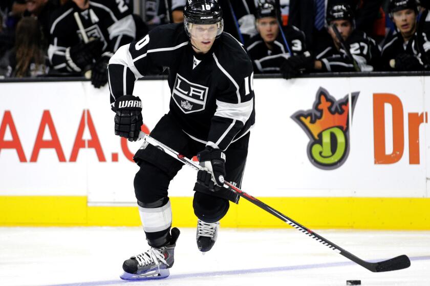 Kings defenseman Christian Ehrhoff bings the puck up ice during a game against the Coyotes on Oct. 9 at Staples Center.