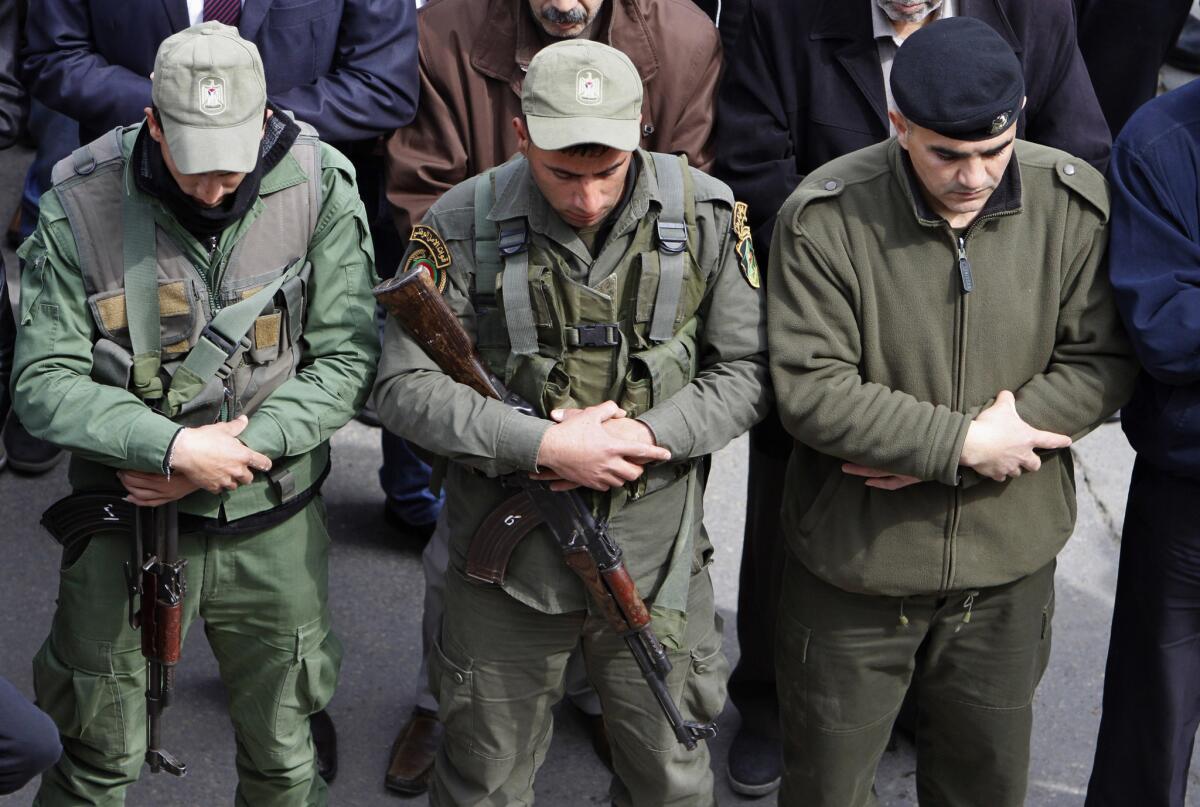 Palestinian security forces pray Tuesday during a funeral for Raed Zeiter, 38, in the West Bank city of Nablus.