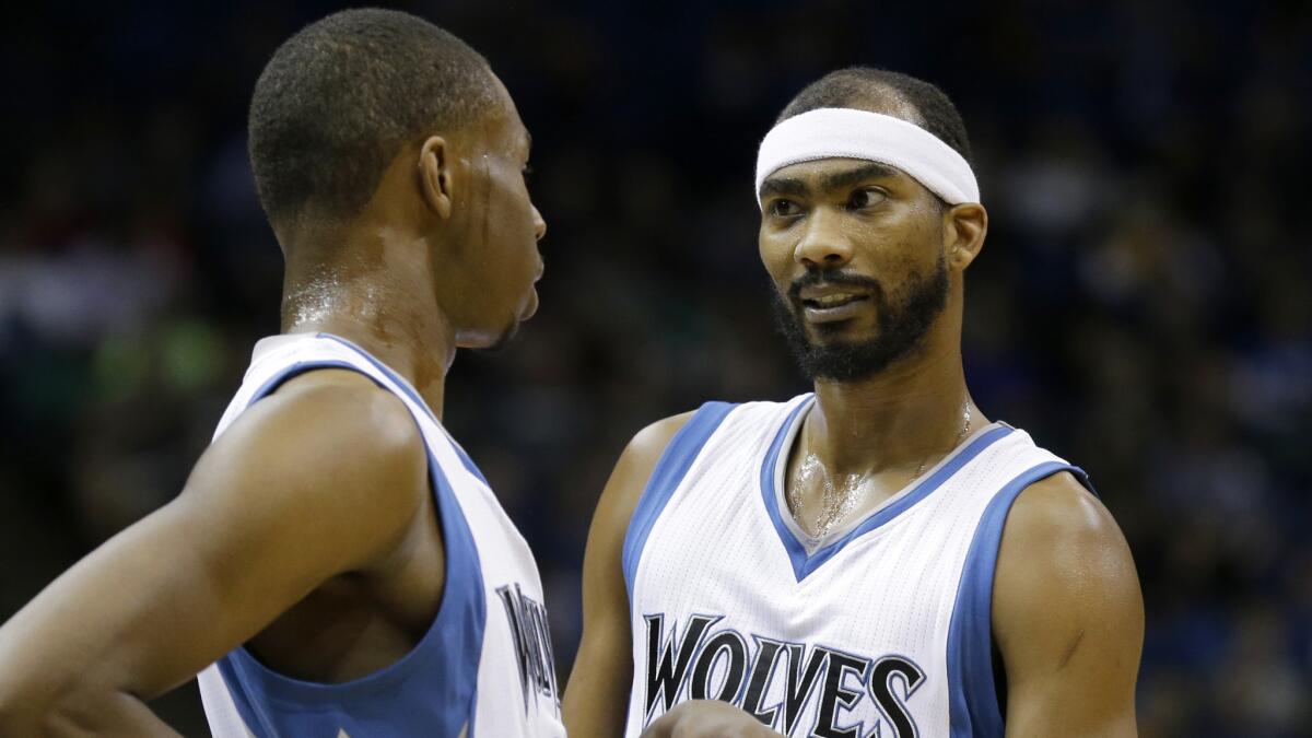 Minnesota Timberwolves teammates Andrew Wiggins, left, and Corey Brewer talk during a game against the Sacramento Kings on Saturday.