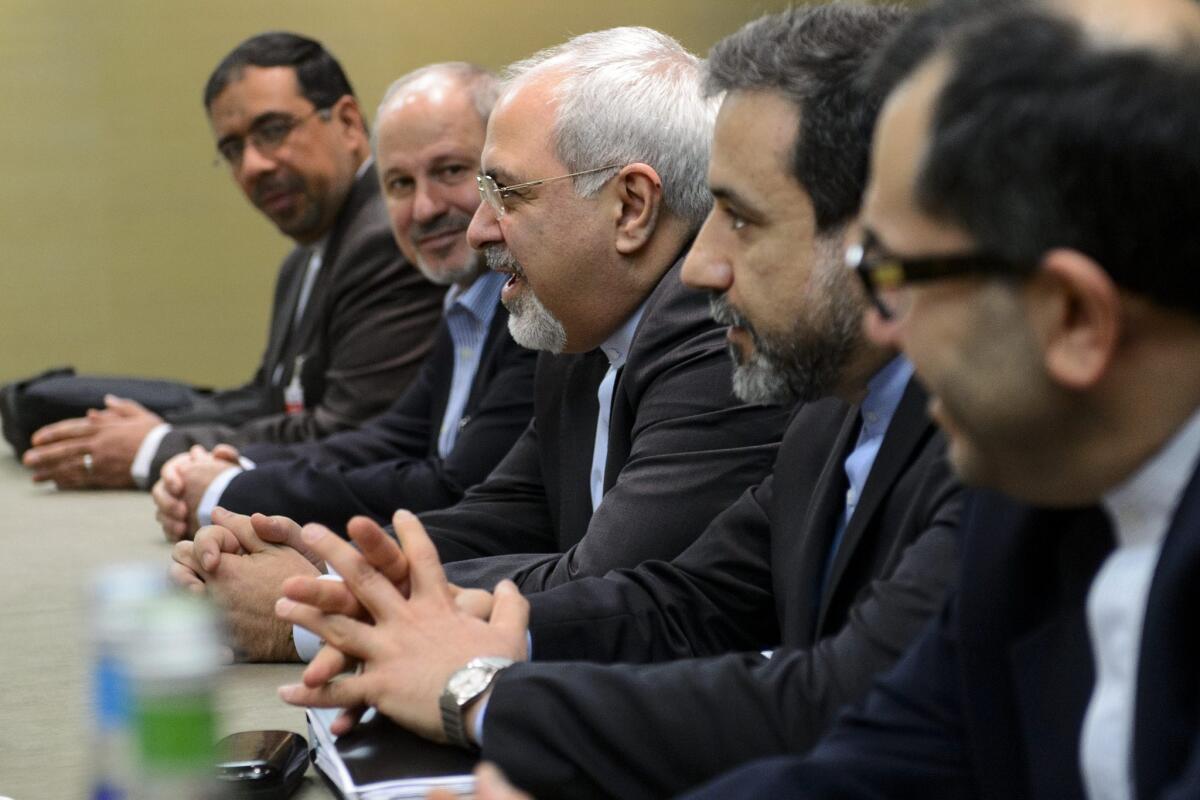 Iranian Foreign Minister Mohammad Javad Zarif, center, attends talks on Iran's nuclear program in Geneva.