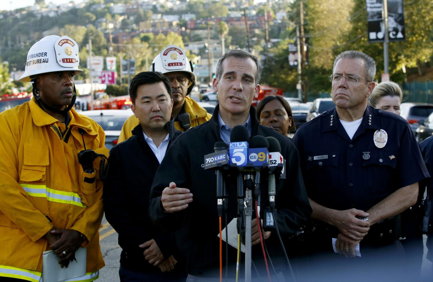 Los Angeles Mayor Eric Garcetti, center, and Police Chief Michel Moore, right, brief the media at a news conference after a gunman held dozens of people hostage inside a Trader Joe's market before surrendering to police in Los Angeles.