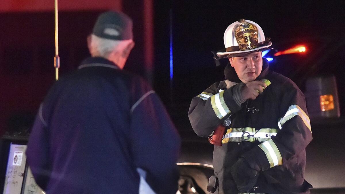 A first responder works at the scene of an explosion and reported standoff in North Haven, Conn., on May 2.