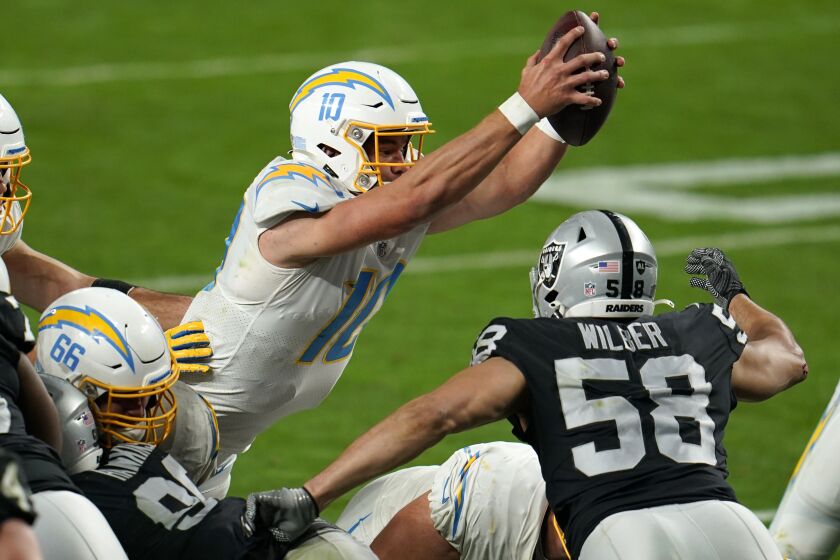Los Angeles Chargers quarterback Justin Herbert #10 scores the game-winning touchdown in overtime against the Las Vegas Raiders in an NFL football game, Sunday, Dec. 13, 2020, in Las Vegas. (AP Photo/Jeff Bottari)
