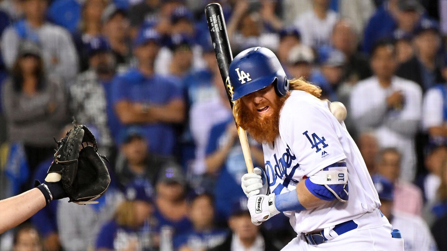 The Dodgers' Justin Turner gets hit by a pitch in the third inning.