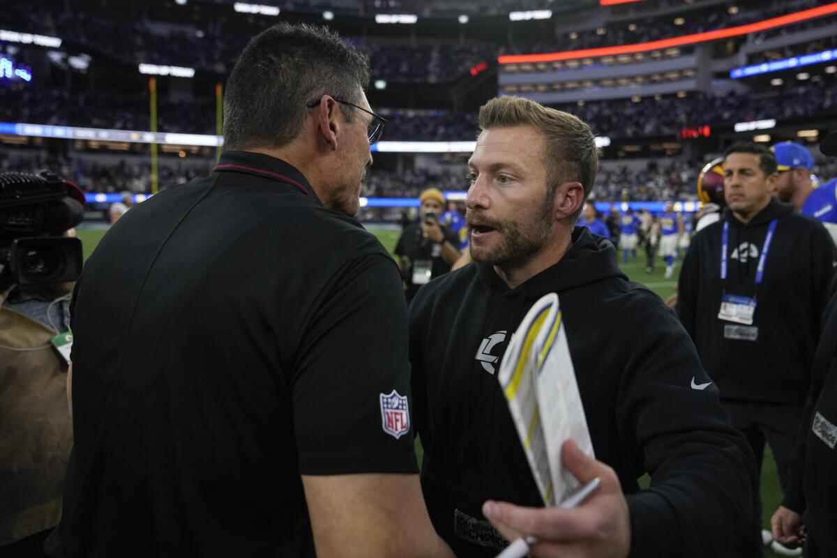Commanders coach Ron Rivera, left, shakes hands with Rams coach Sean McVay after Washington lost the road game.