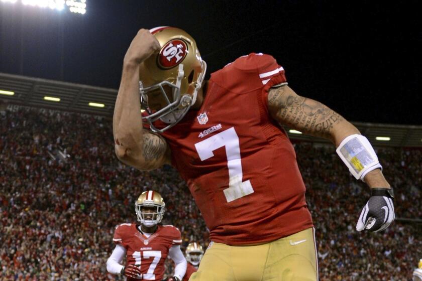 SAN FRANCISCO, CA - JANUARY 12: Quarterback Colin Kaepernick #7 of the San Francisco 49ers celebrates after running in a touchdown in the first quarter against the Green Bay Packers during the NFC Divisional Playoff Game at Candlestick Park on January 12, 2013 in San Francisco, California. (Photo by Harry How/Getty Images) ** TCN OUT ** ORG XMIT: 159347965
