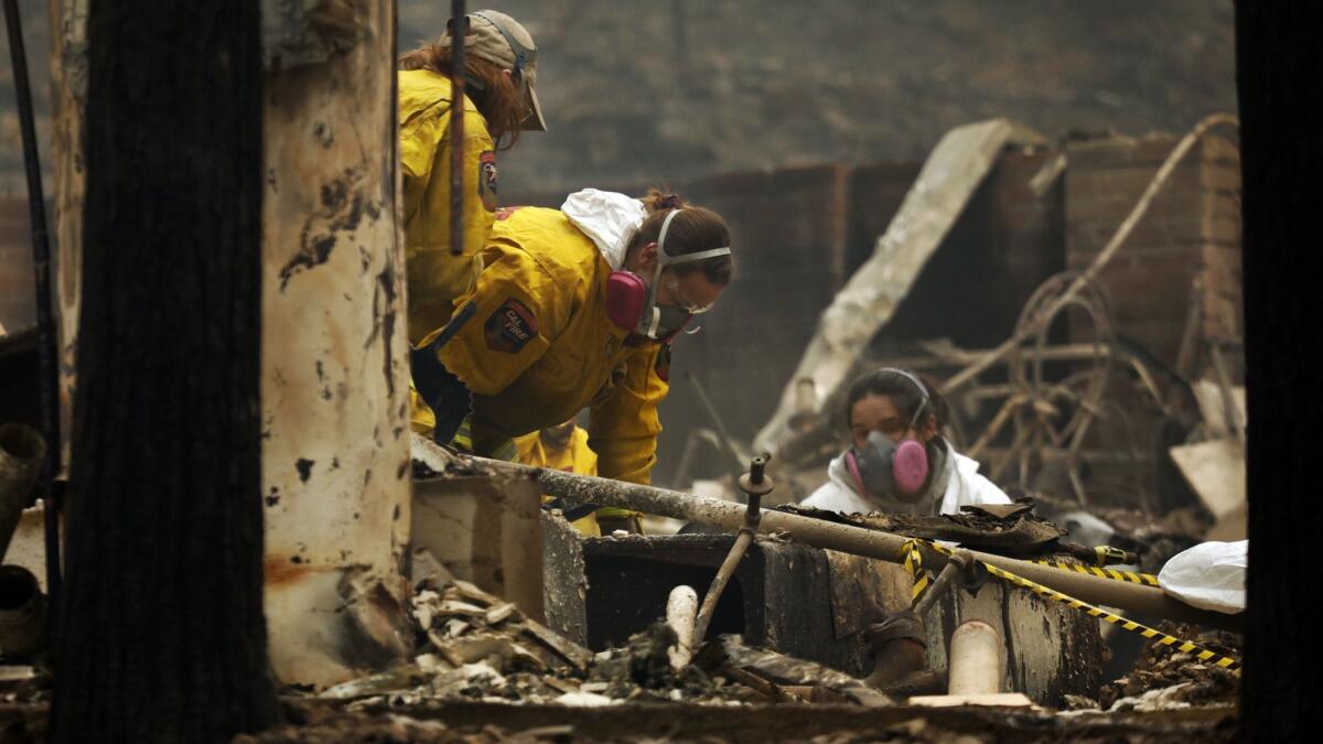 A forensic team investigates the site of a home where remains were found Tuesday in the wake of the Camp fire in Butte County.