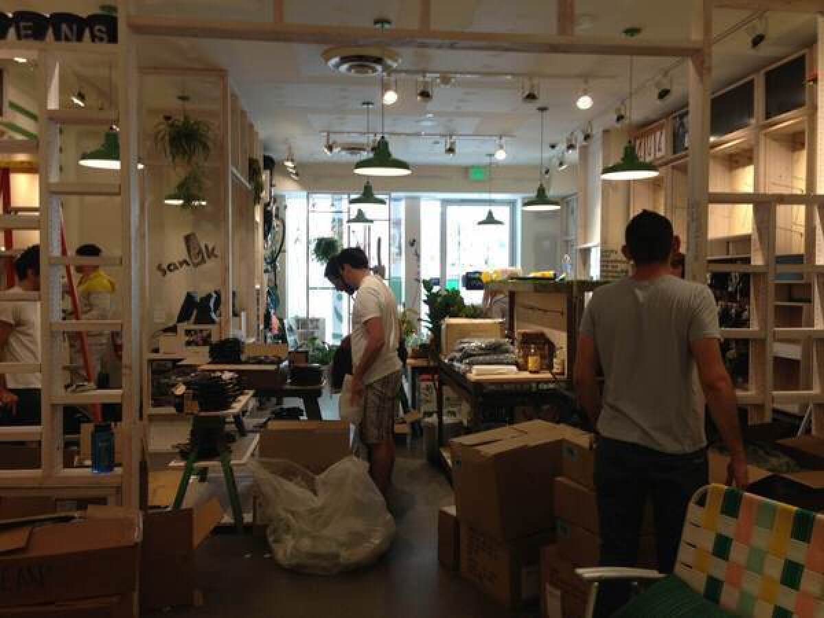 Workers in Santa Monica set up Sanuk's first company-owned store before its Friday opening.