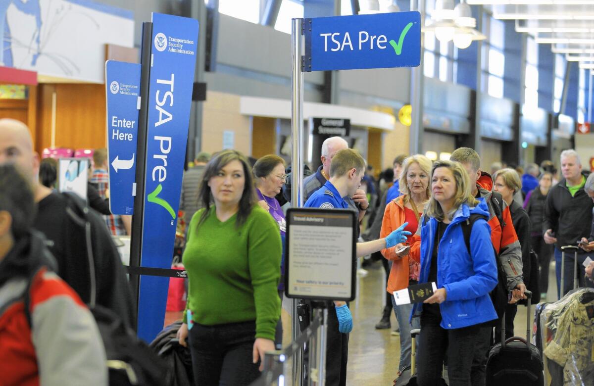 Flier are likely to face long security lines at airports across the country this summer. Above, travelers wait at Seattle-Tacoma International Airport.