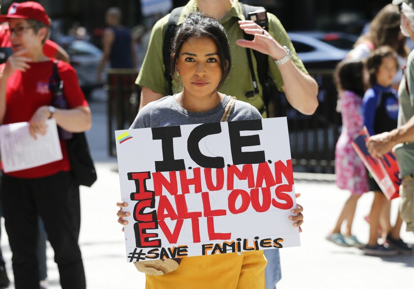 Protesters march to offices of the U.S. Immigration and Customs Enforcement Saturday in Chicago.