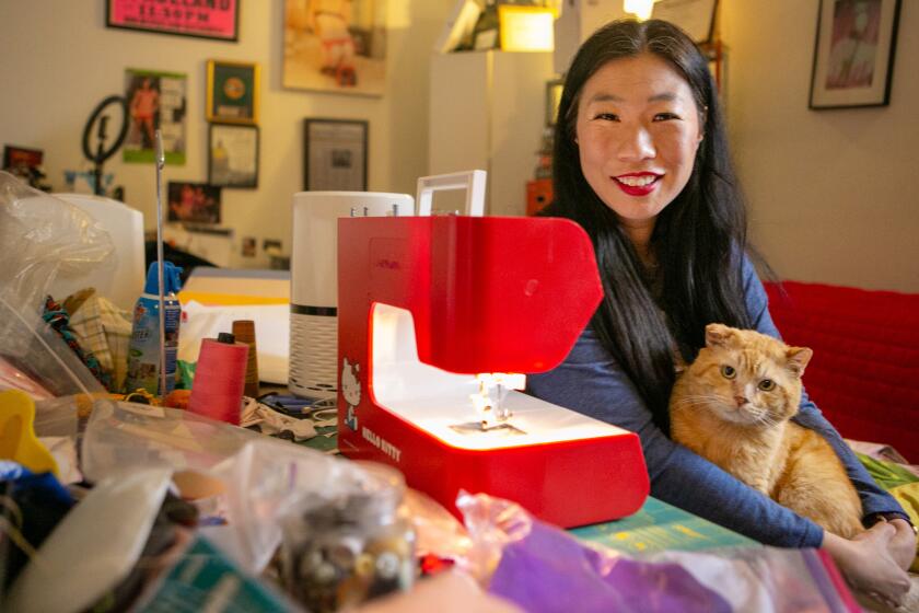 LOS ANGELES, CA - MARCH 25: Performance artist Kristina Wong poses for a portrait in her home on Thursday, March 25, 2021 in Los Angeles, CA. Wong leads the Auntie Sewing Squad, a Facebook group that formed a year ago this week to get masks to people who needed them. (Jason Armond / Los Angeles Times)