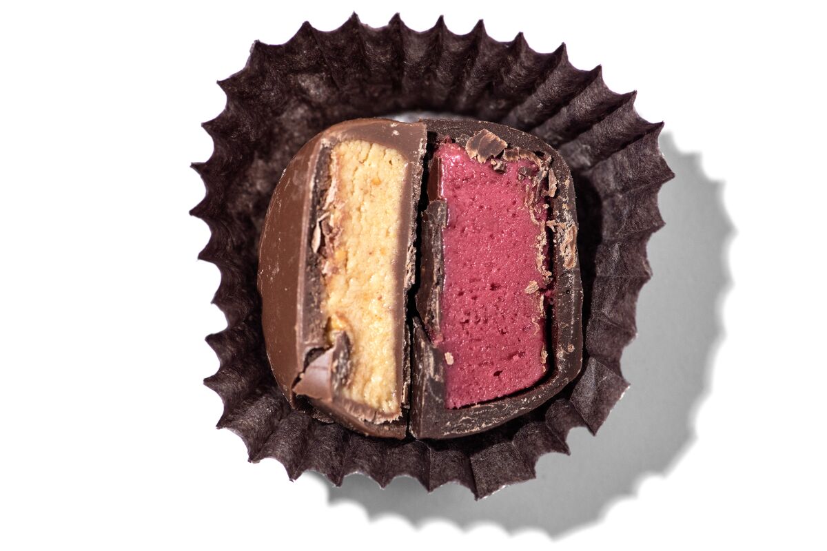 See's Candies Peanut Butter Patty and a Raspberry Cream, each cut in half.