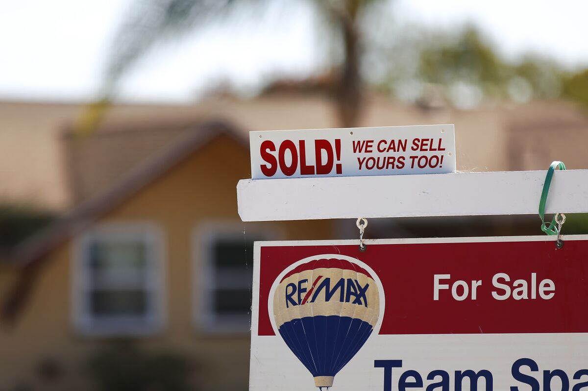 A sold sign is displayed outside of a Clairemont home.