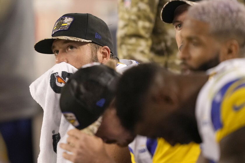 Quarterback Matthew Stafford and Rams teammates sit on the bench.