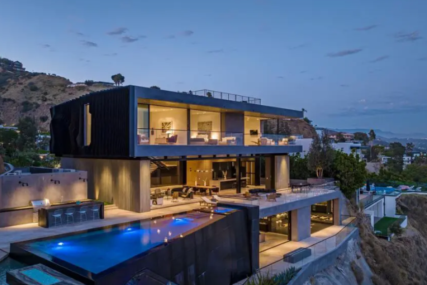 Newly built, the ultra-modern residence spans three stories with five bedrooms, six bathrooms and amenities such as a movie theater and game room.