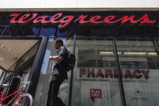 FILE - In this June 25, 2019, file photo signage hangs outside a Walgreens pharmacy in downtown Cincinnati. Walgreens reports financial results on Wednesday, Jan. 8, 2020. (AP Photo/John Minchillo, File)