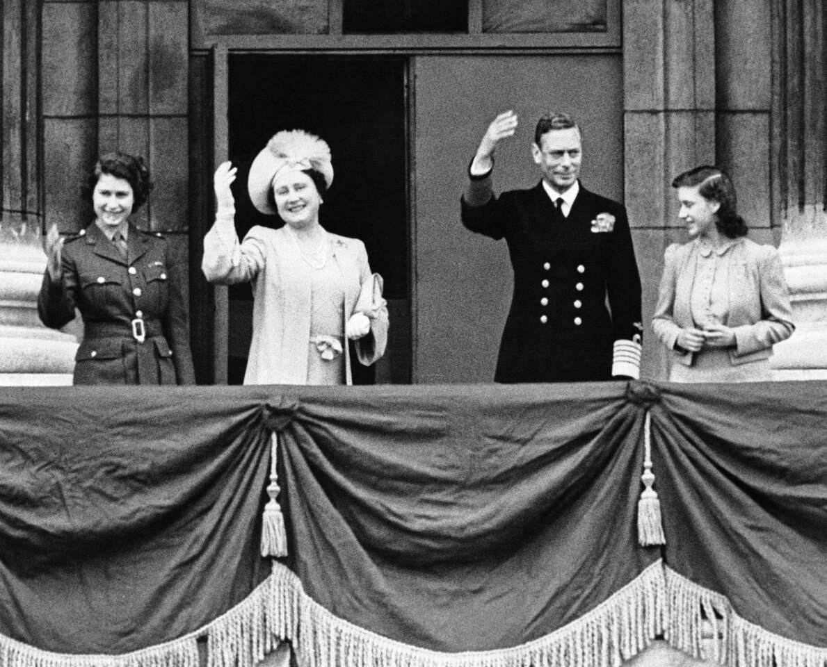 Princess Elizabeth, from left, Queen Elizabeth, King George VI and Princess Margaret stand on a balcony in Buckingham Palace, London on May 8, 1945 and wave to Londoners celebrating the official announcement of Germany's unconditional surrender.